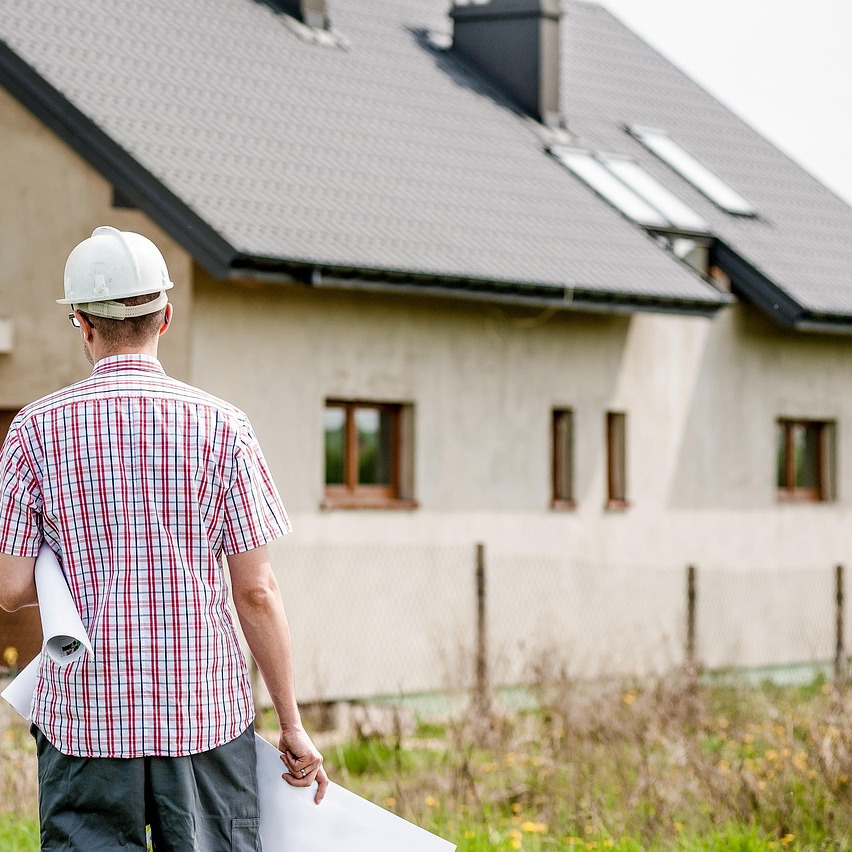 roofing contractors installing shingles on a house roof